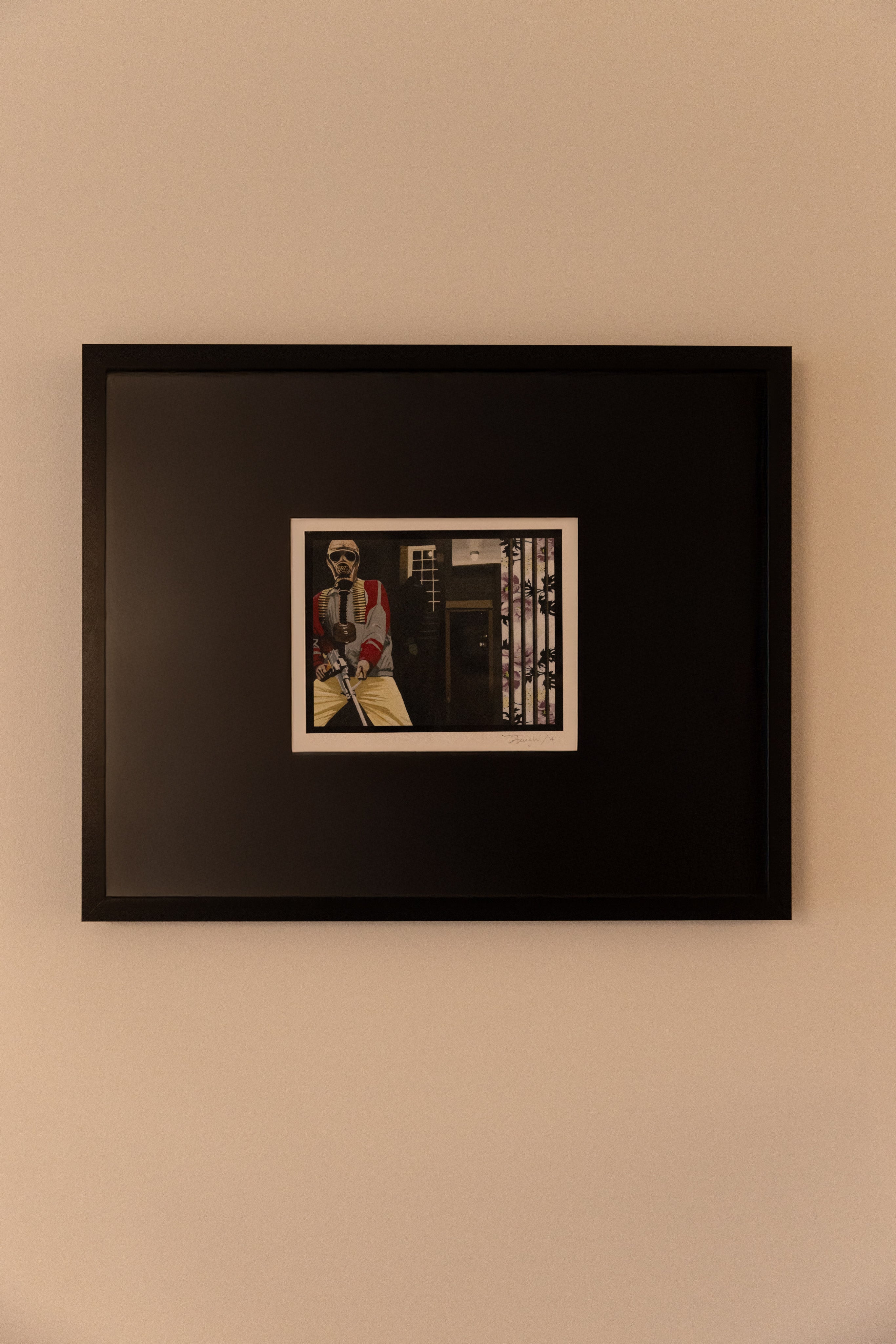 Framed print by artist Diane Feught on a beige wall.