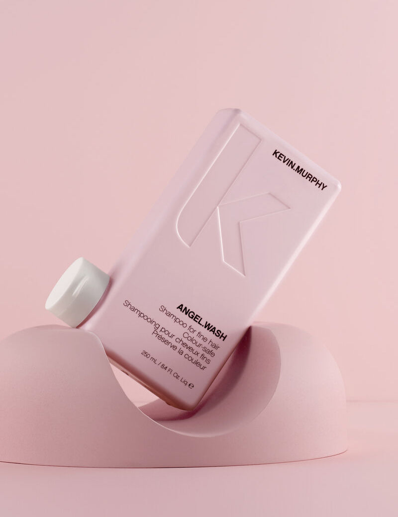 Kevin Murphy Angel Wash shampoo bottle on a pink background