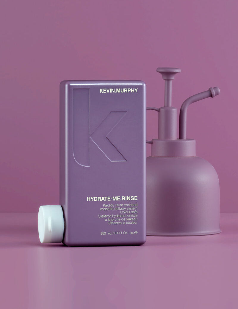 Kevin Murphy Hydrate Me Rinse bottle and pump on a pink background