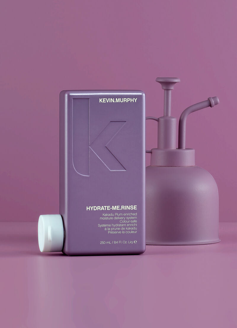 Kevin Murphy Hydrate Me Rinse bottle and pump on a pink background