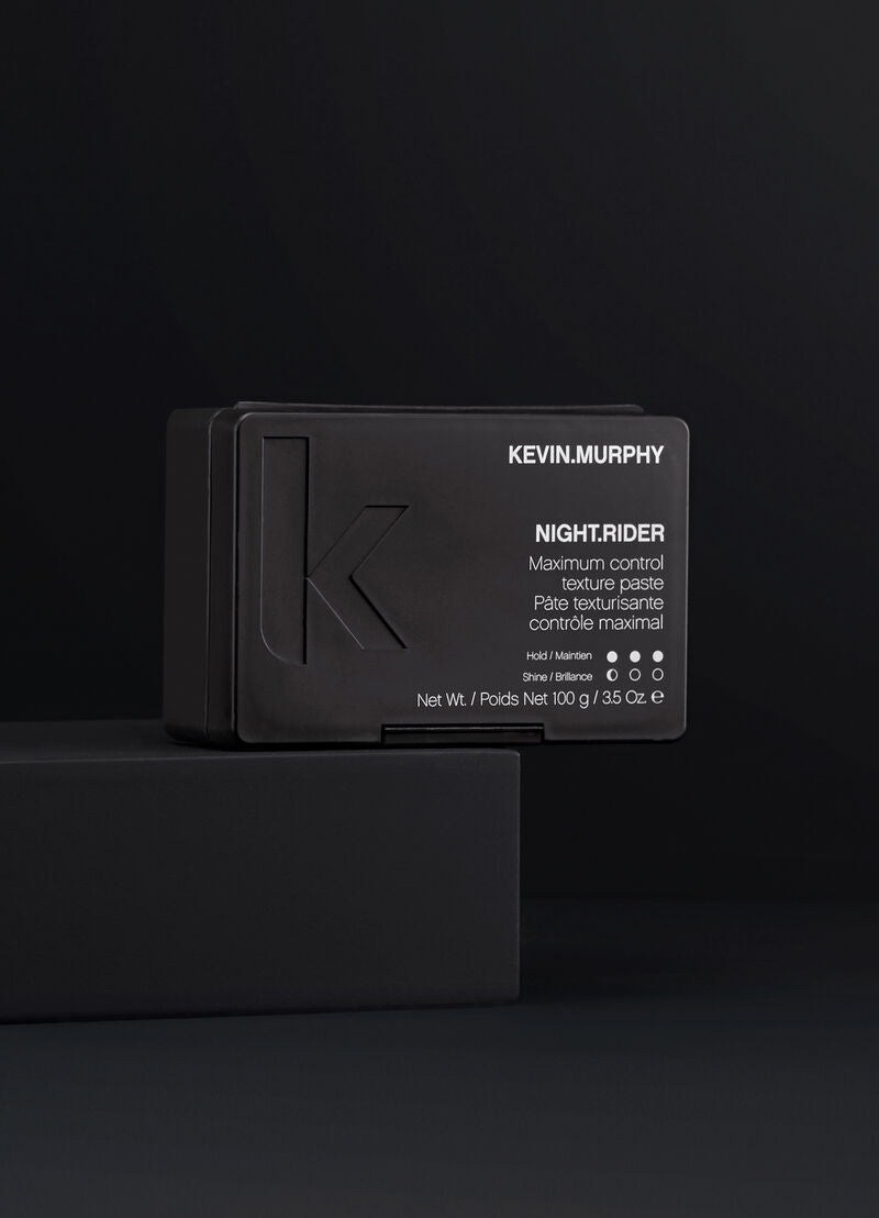 Kevin Murphy hair product packaging on a black background