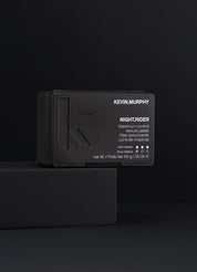 Kevin Murphy hair product packaging on a black background
