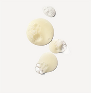 Three droplets of shampoo on a light gray background