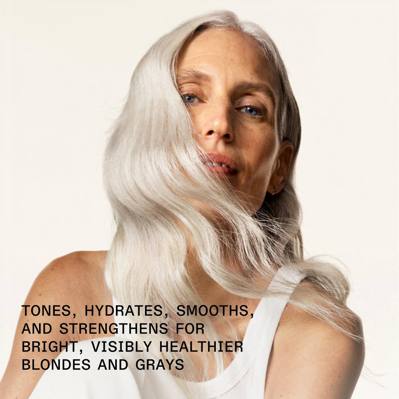 Woman with white hair against a plain background with text about hair care.