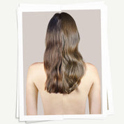 Person with long, wavy hair on a plain background