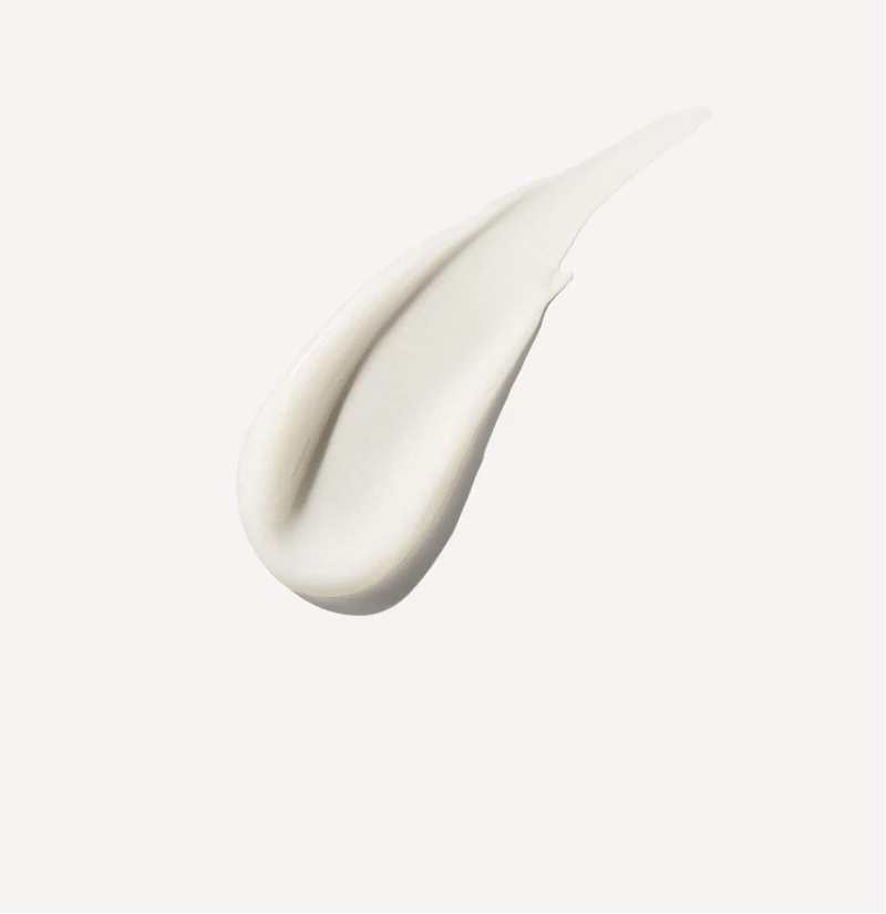 Close-up of a white cream or paint swatch on a light gray background