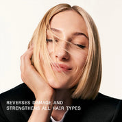Woman with blonde hair touching her face against a white background, with text about hair care product benefits.