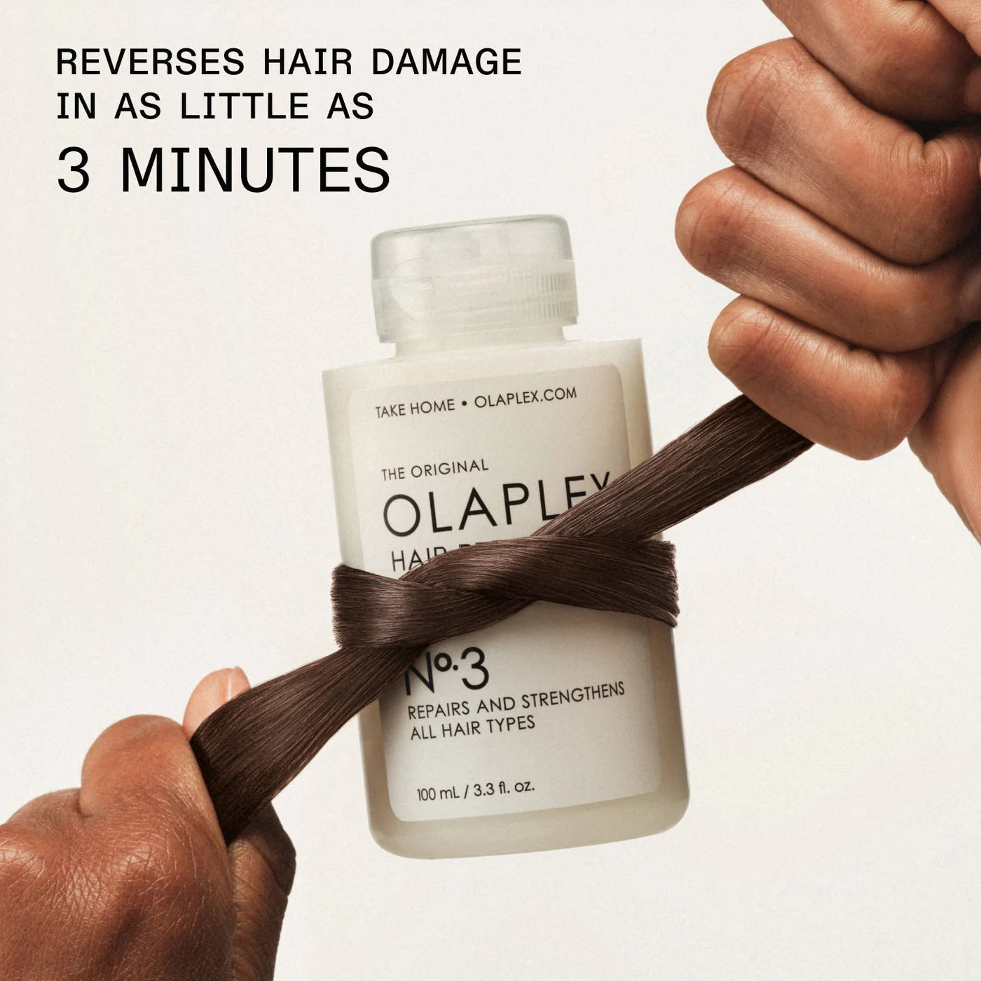 Olaplex hair product with a bottle and a strand of hair, showing its effectiveness.