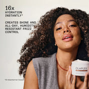 Woman holding Olaplex product with text about hydration and frizz control on a light background