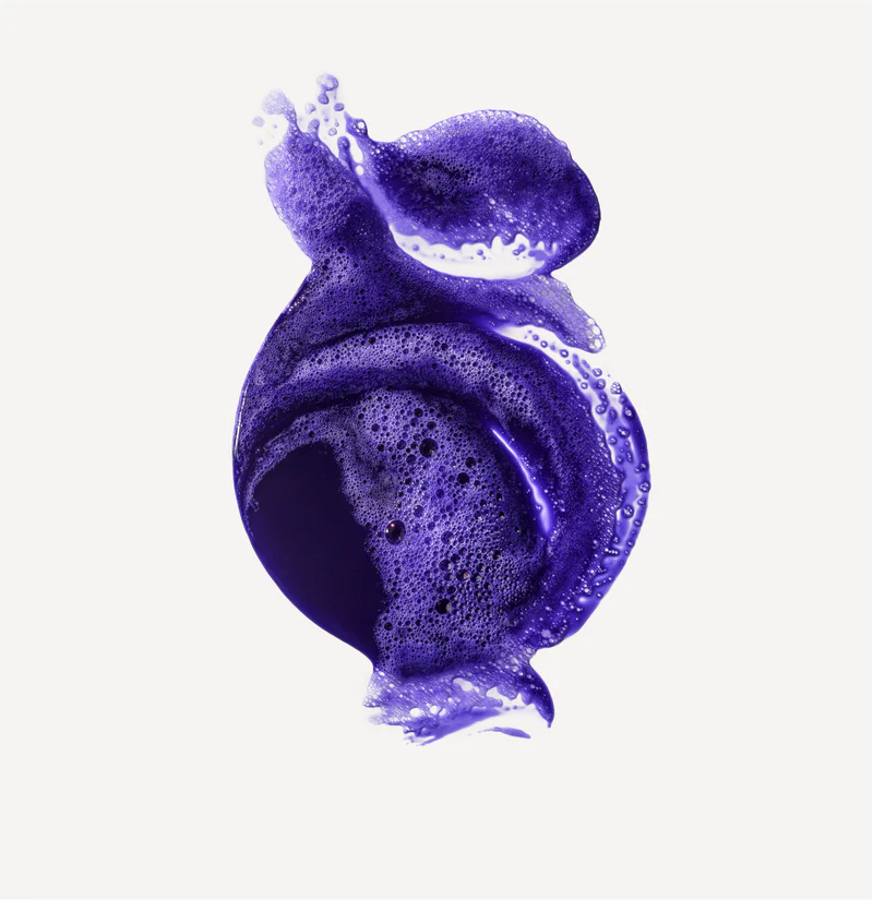 Purple shampoo foam texture on a white background
