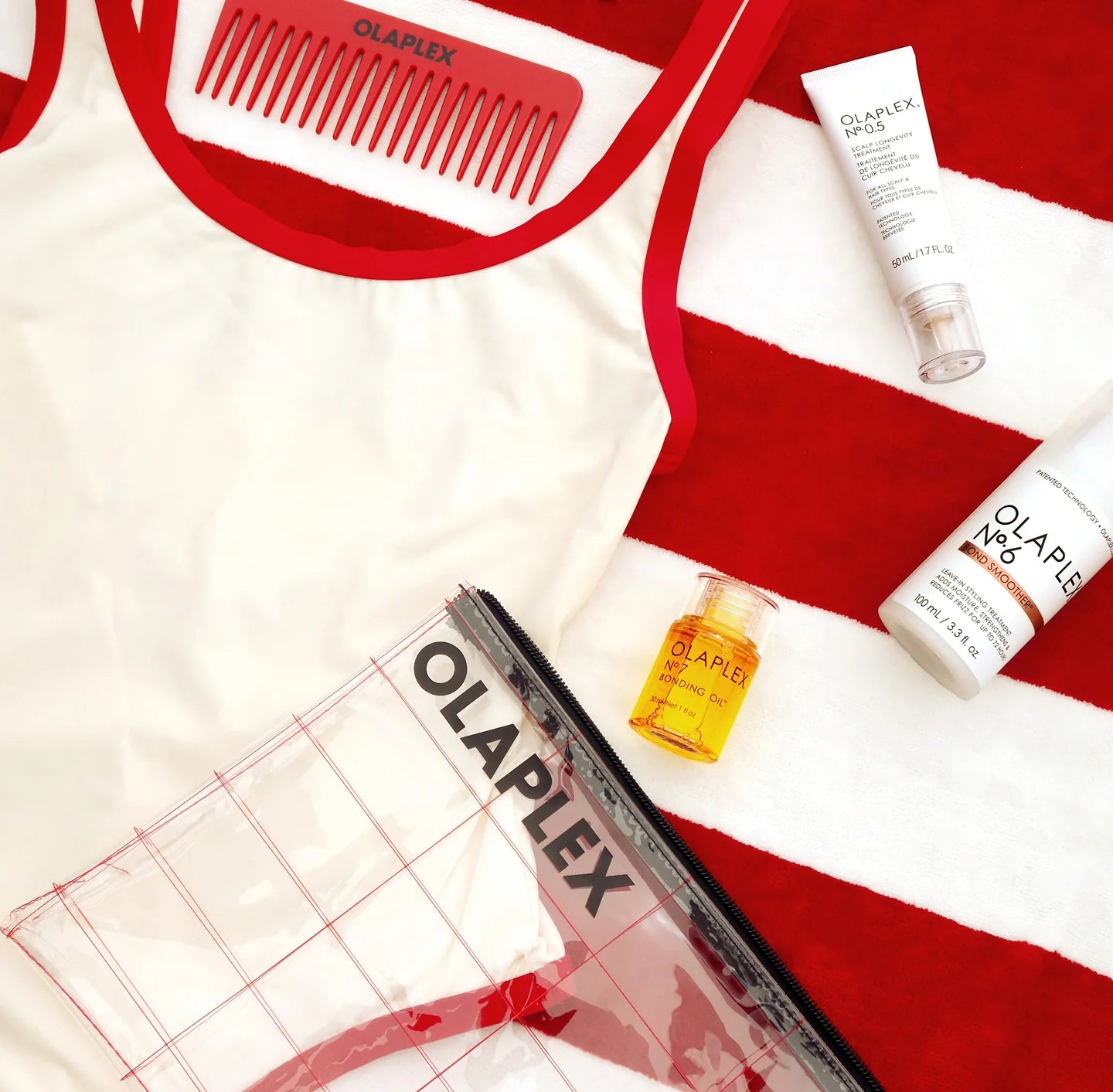 Olaplex hair care products and comb on a red and white striped background