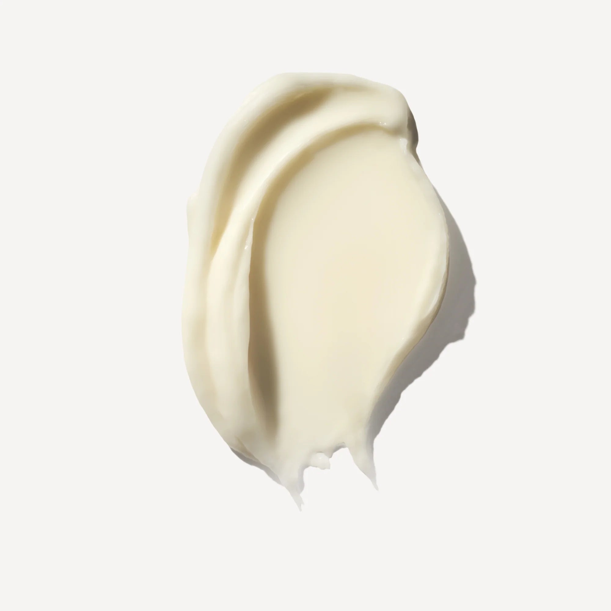 Swirl of light beige mask cream on a white background