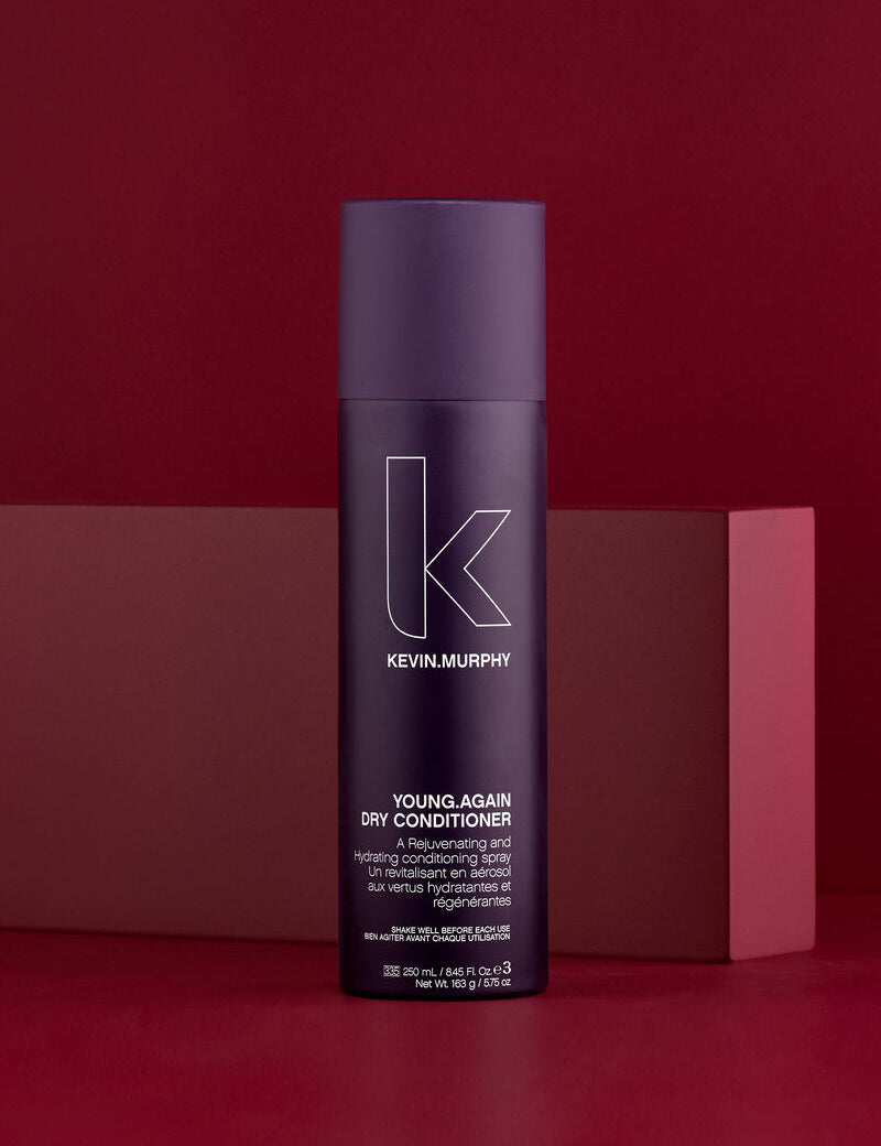 Kevin Murphy Young Again Dry Conditioner bottle on a red background