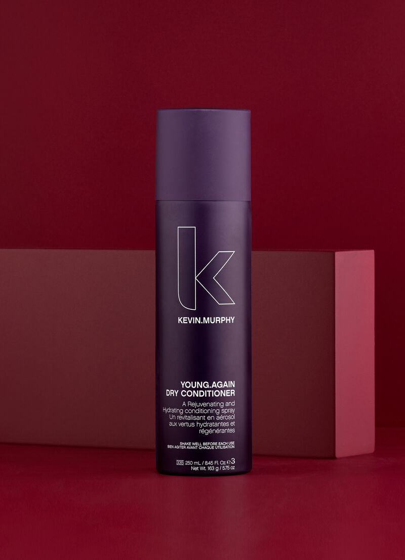 Kevin Murphy Young Again Dry Conditioner bottle on a red background