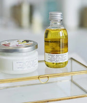 Bottle of oil and container on a glass shelf with a blurred background