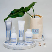 davines products on a marble tray with a plant and bag in the background