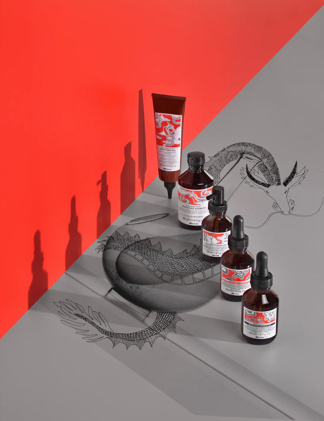 products including bottles and a tube on a gray surface with a red background