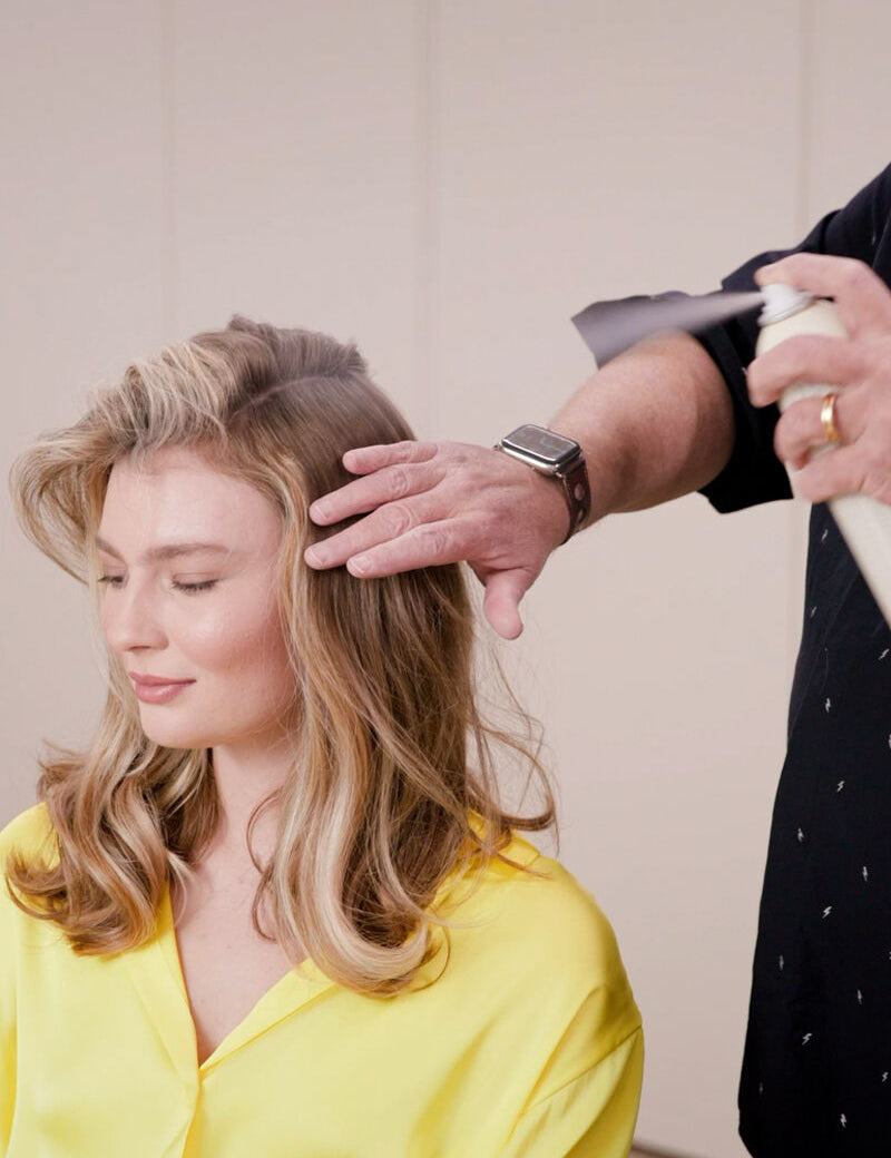 model with a stylist spraying kevin murphy on hair