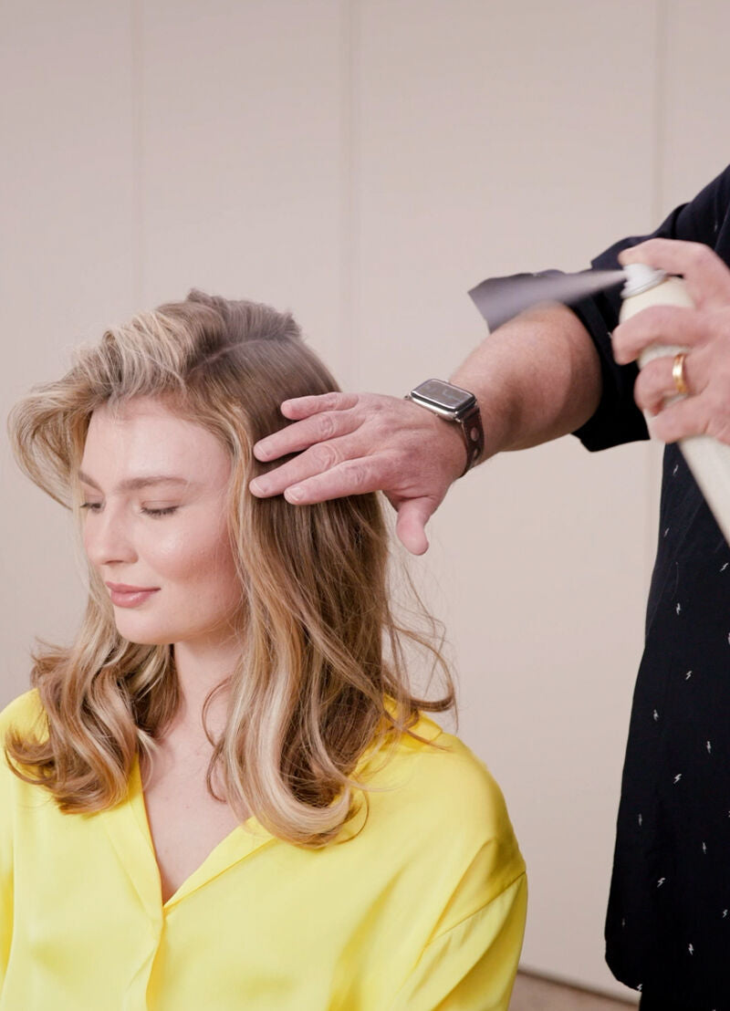 model with a stylist spraying kevin murphy on hair