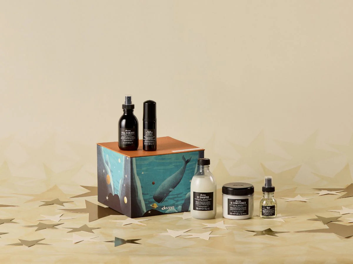 Set of Davines products including bottles, jars, and a box on a beige background