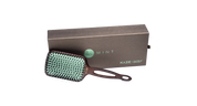 Hairbrush with green bristles and handle on a white background