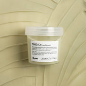 Jar of Momo conditioner on a textured beige background