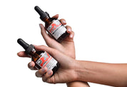 Two bottles of a product held in hands against a white background