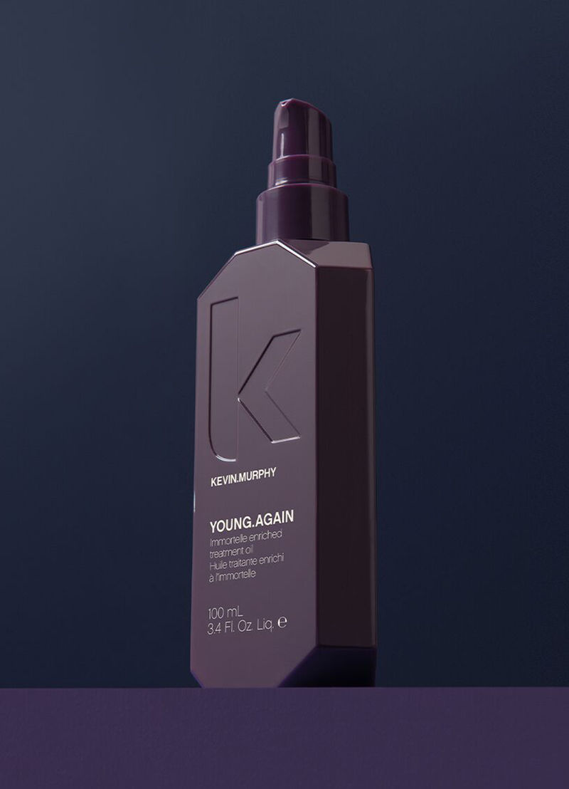 Kevin Murphy Young Again hair product bottle on a dark background